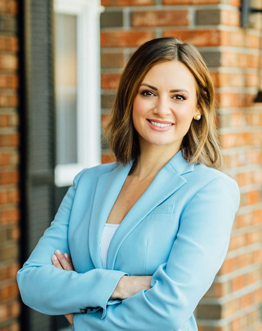 Smiling woman in light blue blazer