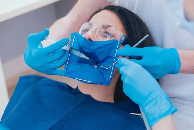 Patient with dental dam during treatment
