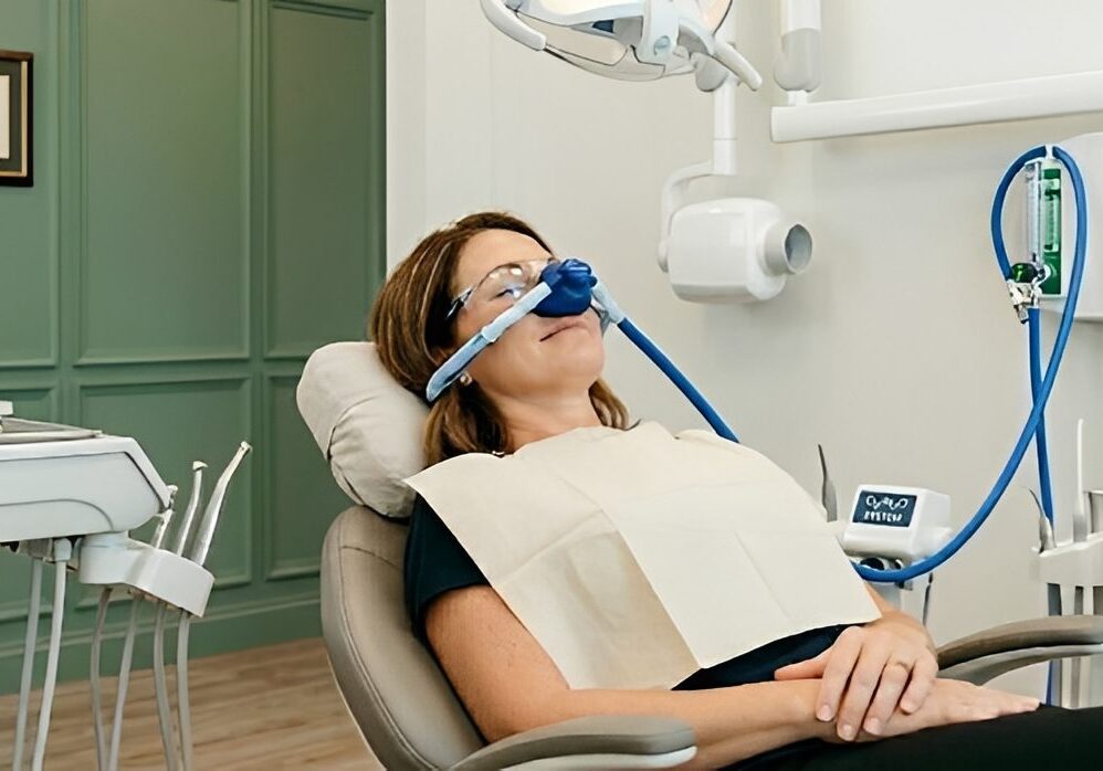 Patient reclining in dental chair with nitrous mask